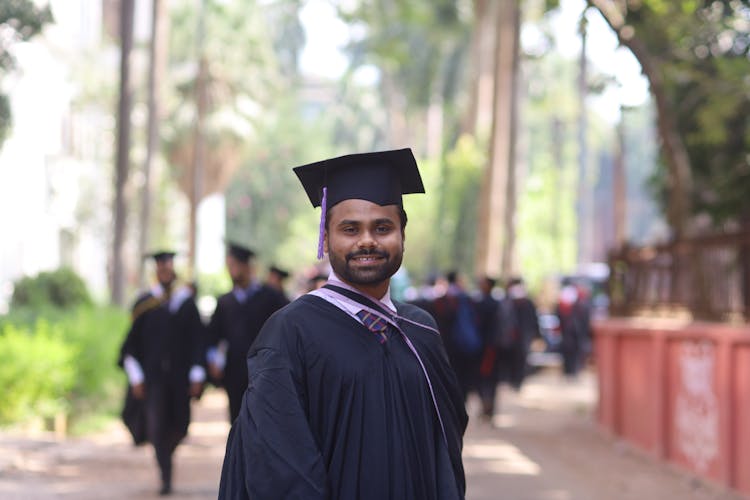 A Man Wearing A Graduation Toga