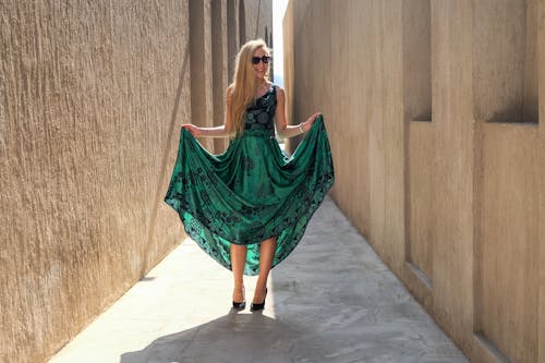 Photo of Woman Holding Her Green Dress