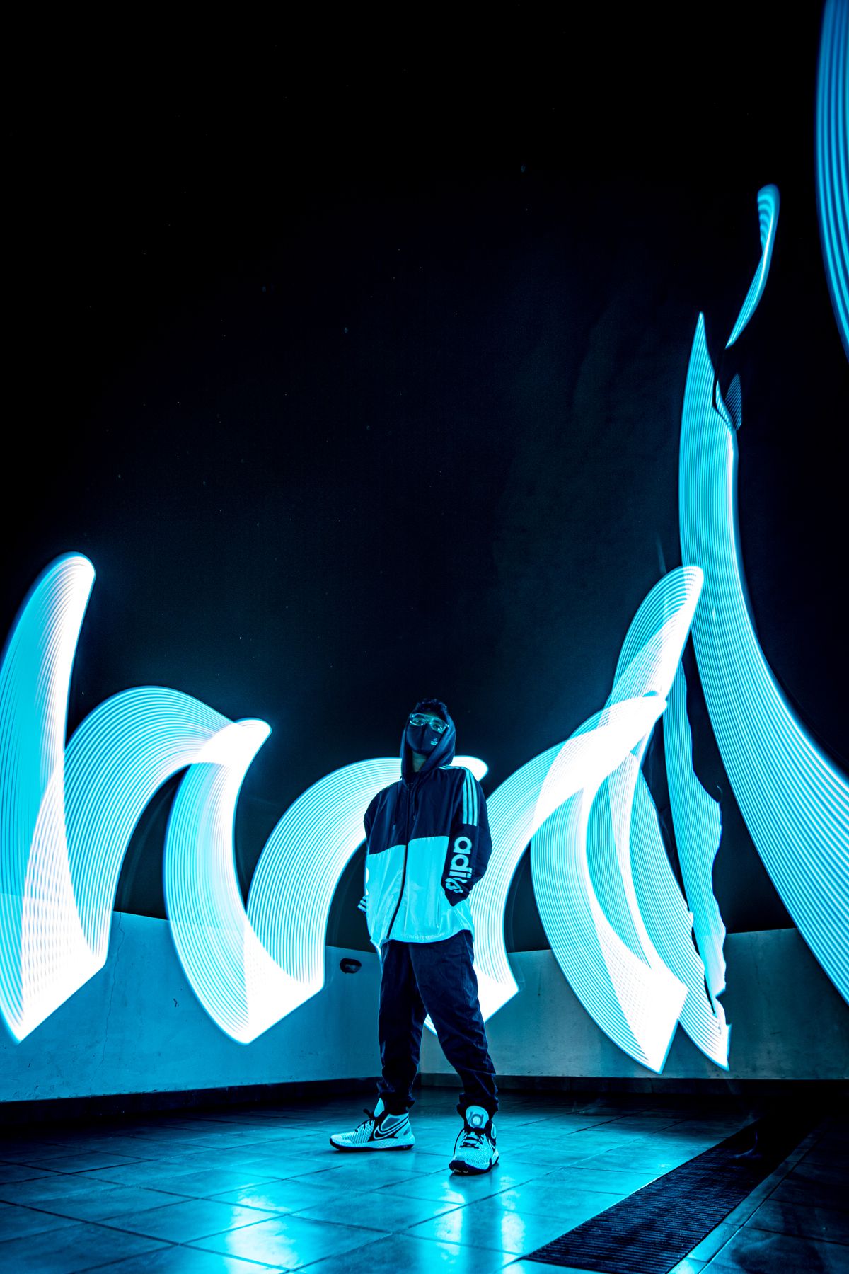 Figure surrounded by sculptural blue light