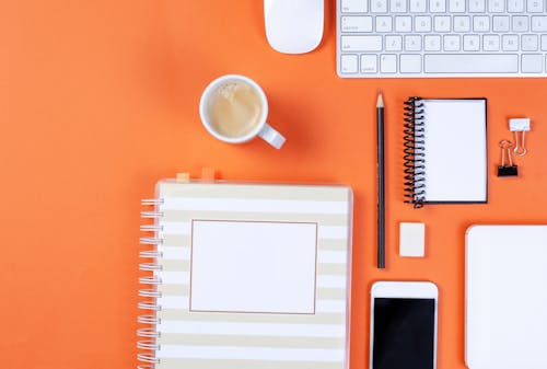 Photo of White Office Equipment on an Orange Background