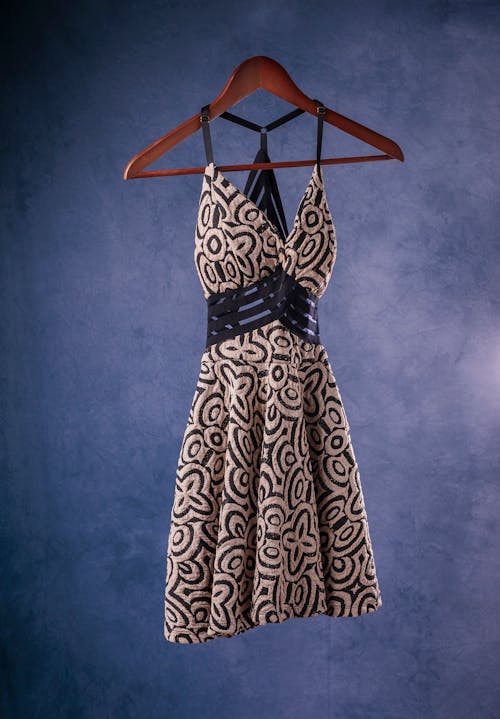 A Spaghetti Black and White Dress Hanging on a Wooden Hanger