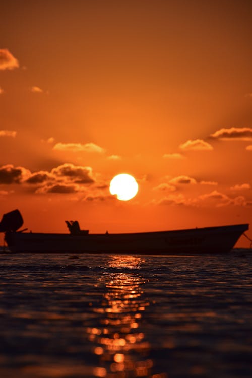 Sun on Yellow Sky over Boat at Sunset