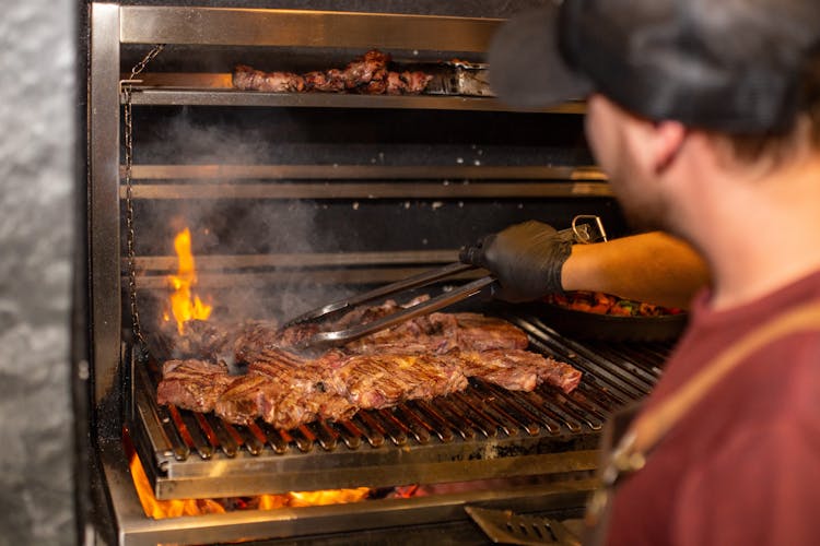 Person Grilling Meat