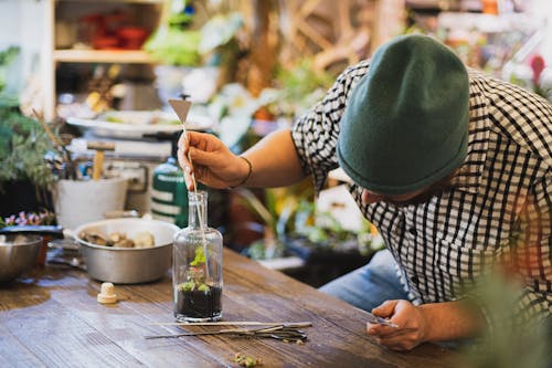 Florist  Making Plant Design Inside a Glass Bottle