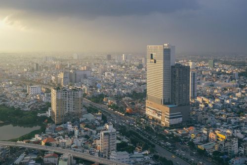 Free Majestic aerial view of Ho Chi Minh City, with skyscrapers under an overcast sky, capturing urban vibrancy. Stock Photo