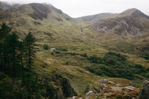 Free Breathtaking aerial view of Snowdonia National Park with lush green valleys and rugged mountains. Stock Photo