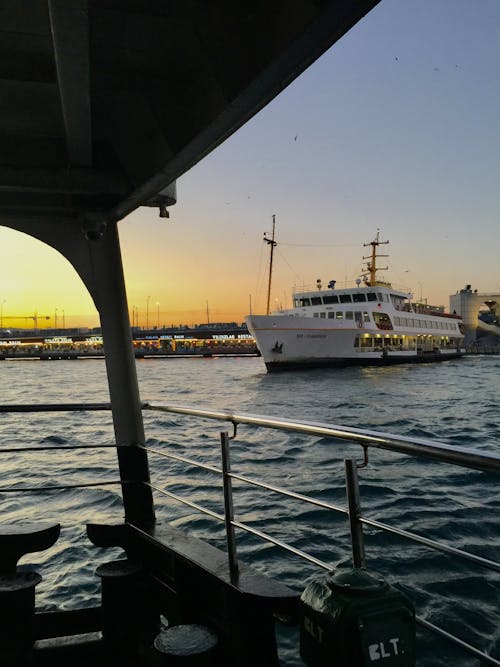 Photo of a Ship in a Harbor at Dusk 