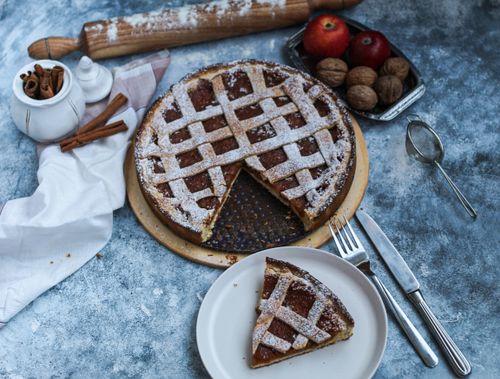 Free Homemade apple pie with cinnamon and walnuts on a rustic table setting. Stock Photo