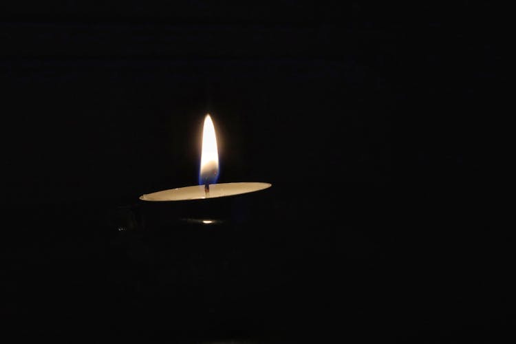 Lighted Candle In Dark