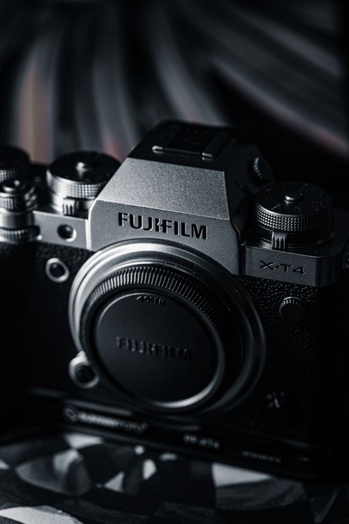 Free Detailed close-up of a modern camera with a dark and moody aesthetic, perfect for media use. Stock Photo