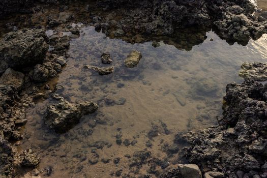 A natural tide pool surrounded by rocks in Fortaleza, Brazil.. natural, tide, pool