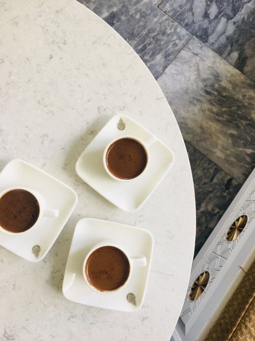 Free Aerial view of three cups of Turkish coffee on a white table, indoors. Stock Photo