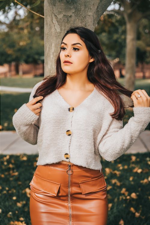 Woman in wrap cardigan with leather skirt