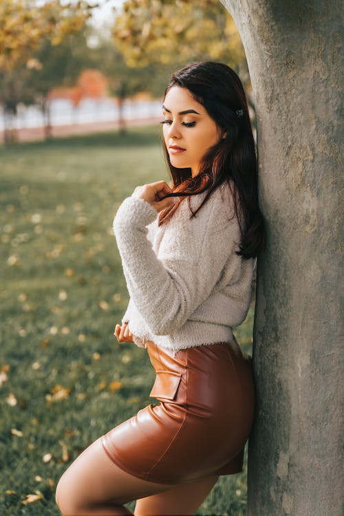 Portrait of a Woman Standing by a Tree