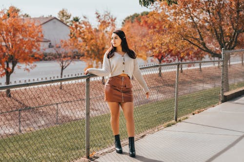 Woman in Skirt near Fence