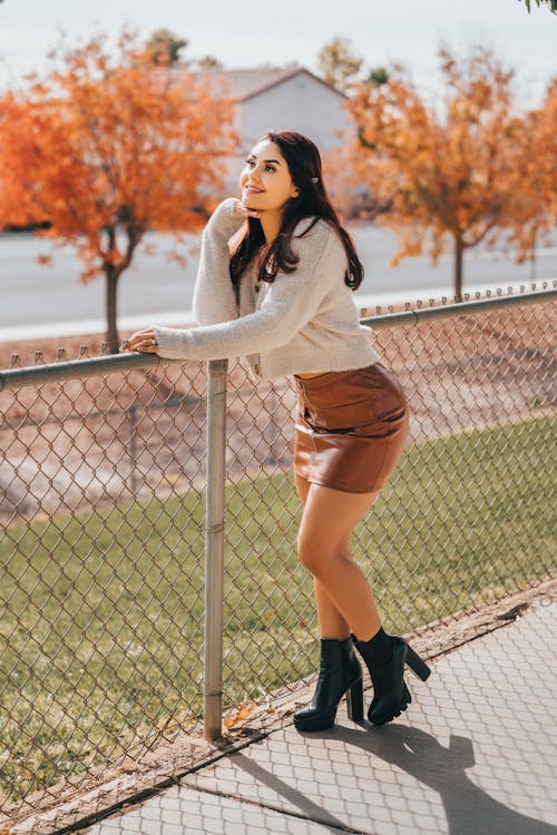 Woman Standing Near Chain Link Fence