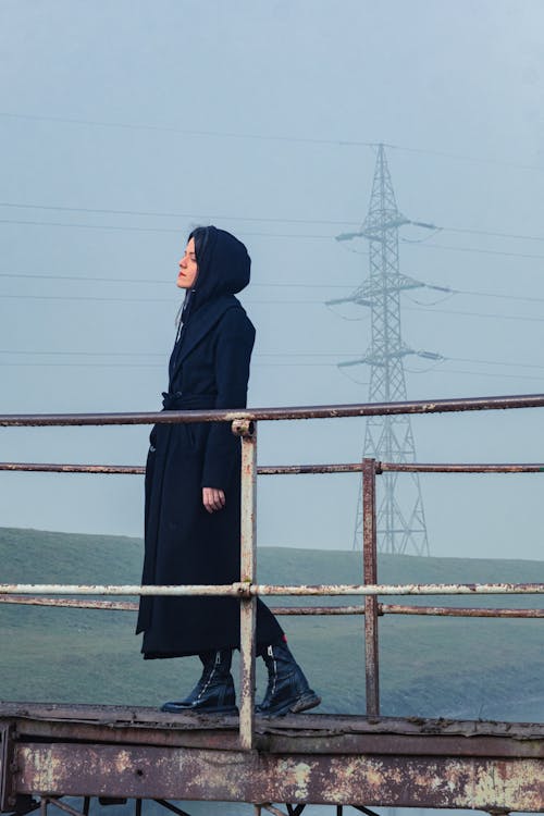 Free Woman in Black Hijab Standing on Brown Dock Stock Photo