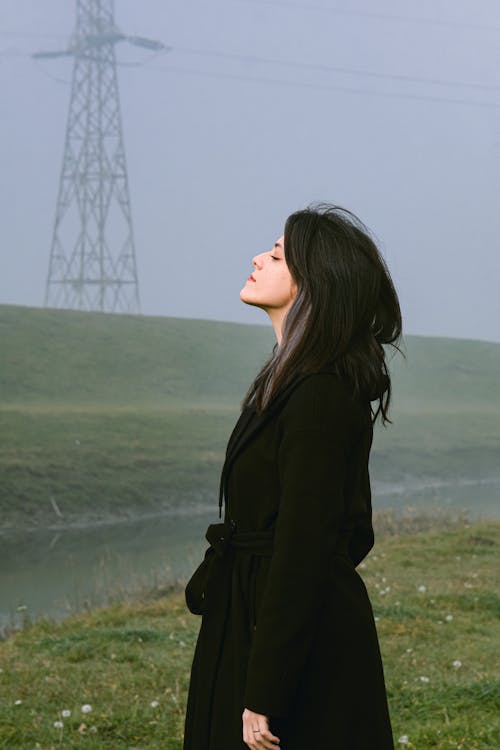 Woman Wearing Coat on Foggy Meadow