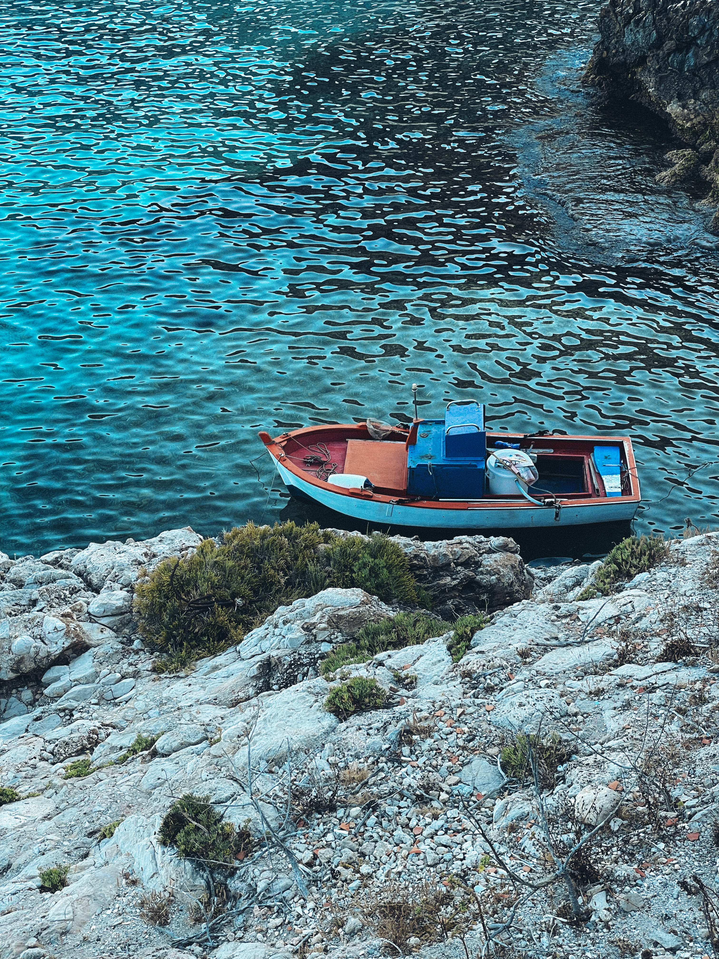 Empty Boat near Rocks on Shore · Free Stock Photo
