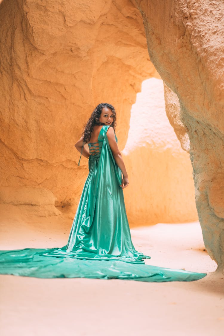 Woman Wearing A Green Dress In A Cave 