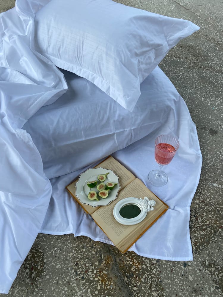 Open Book And Snacks On The Bed Outdoors 