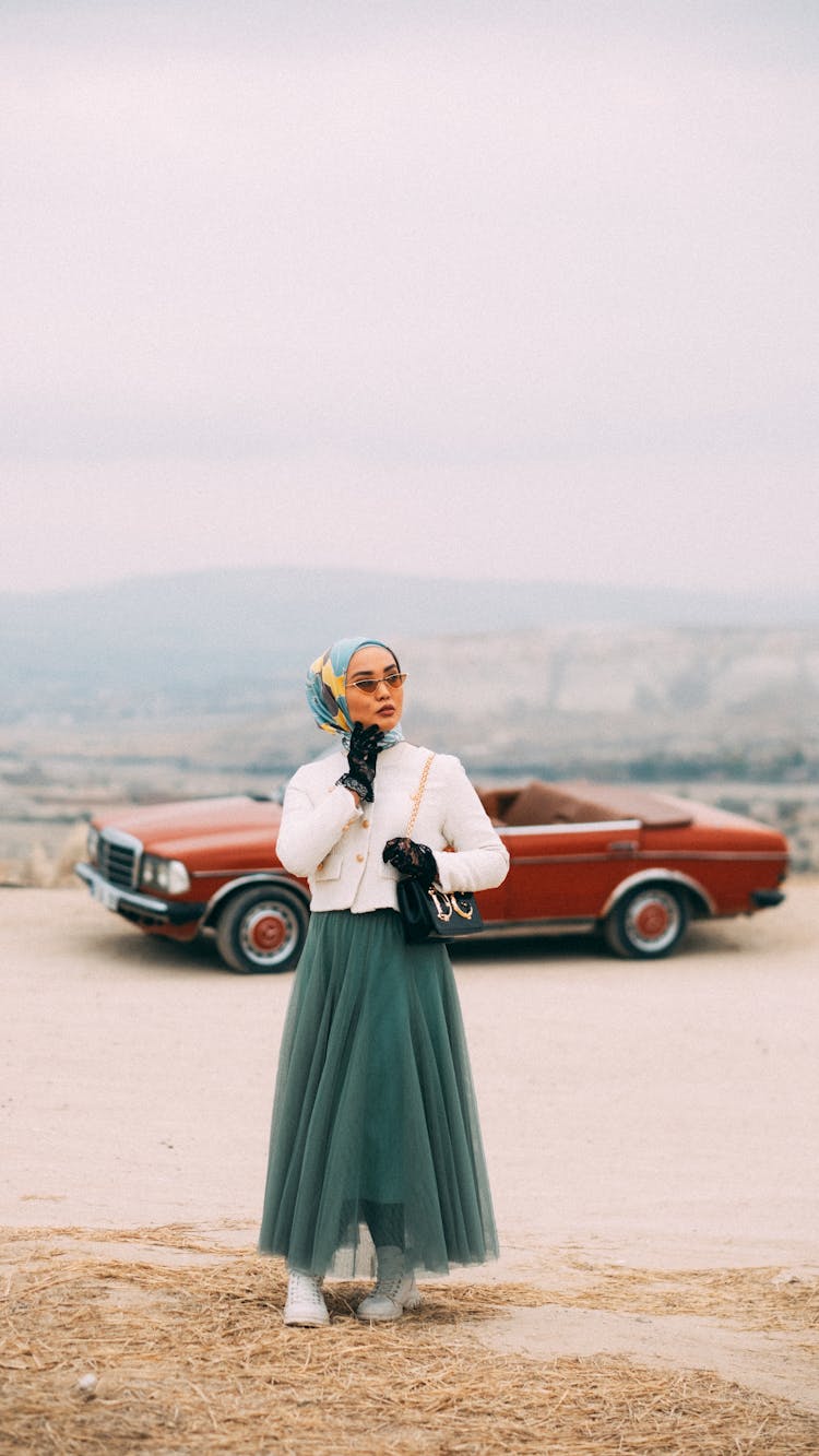 Woman In Hijab And Dress And Car Behind