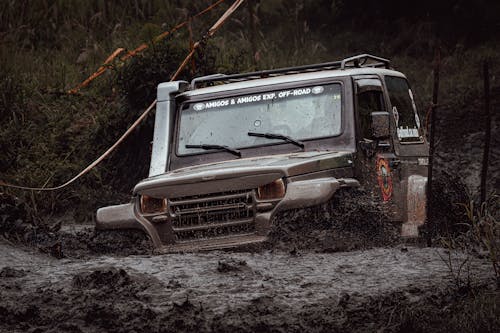 Person Diving a Troller Four Wheel Drive on Dirt Road
