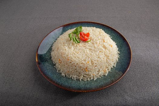 Appetizing basmati rice served on a plate with garnishment for visual appeal.