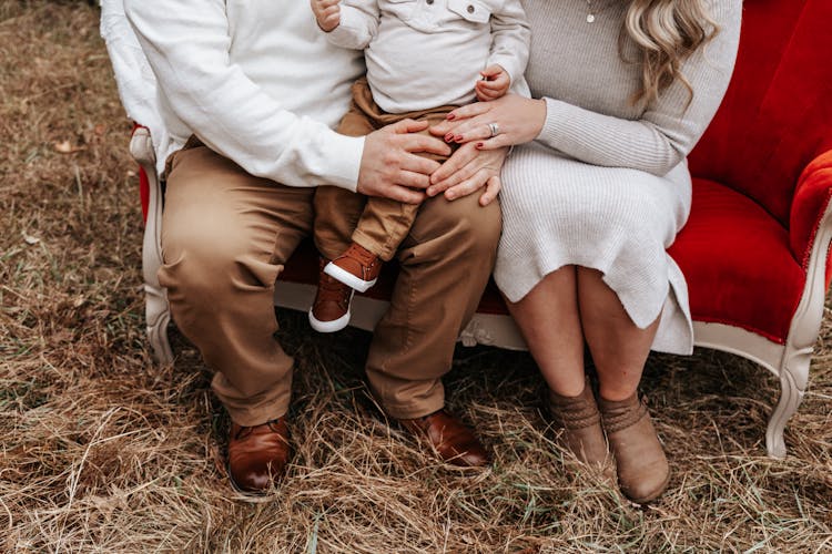 Close Up Of Couple Sitting With Child