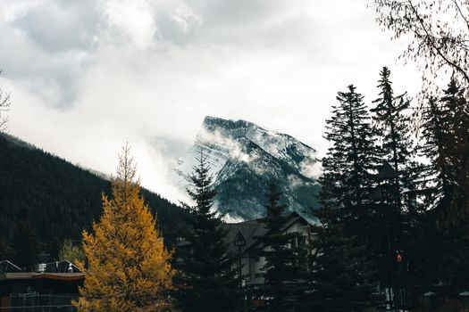 Capture the beauty of Banff with its majestic mountains and lush forests in autumn.