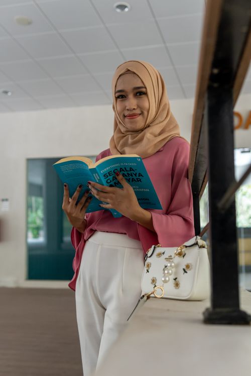 A Girl in Hijab Reading a Book · Free Stock Photo