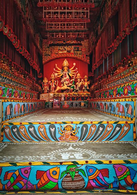 Vibrant Durga idol artfully displayed in Kolkata festival setup, showcasing intricate ornamentation.