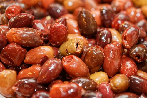 Free Vibrant close-up view of assorted shiny olives, highlighting their natural richness and texture. Stock Photo