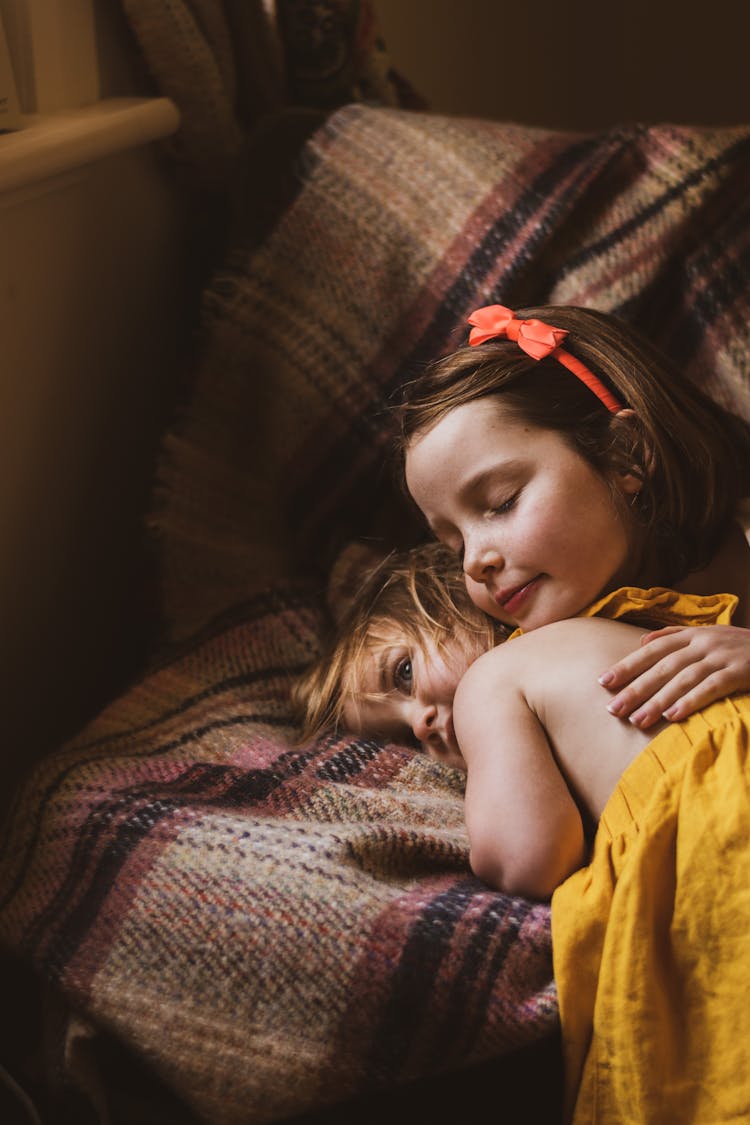 Girls Lying Together On Couch