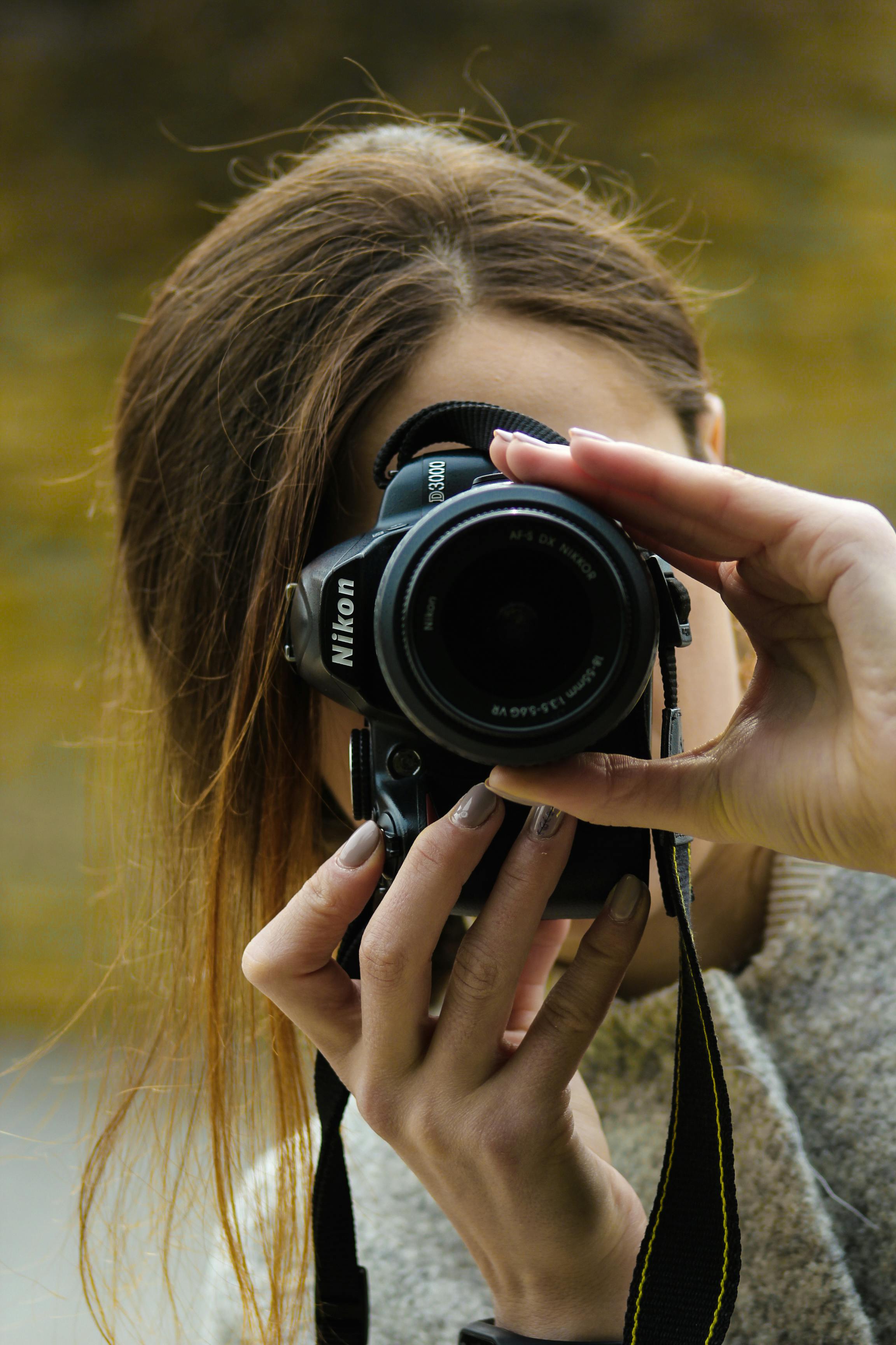 Close-up Photography of Woman Using Black Nikon Dslr Camera