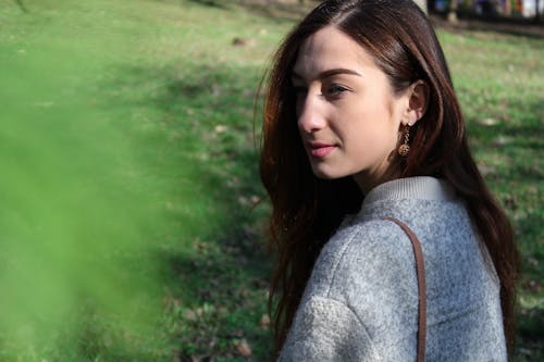 Woman in Gray Sweater Beside Grass Field