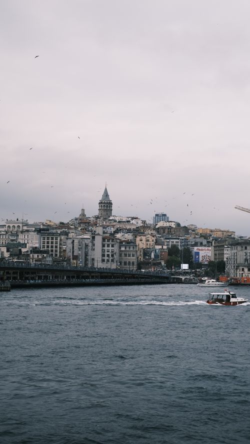 Free Beautiful waterfront view of Istanbul featuring the iconic Galata Tower and bustling cityscape. Stock Photo