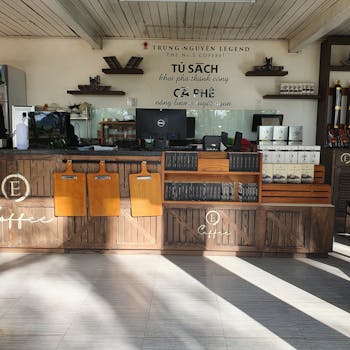 Cozy coffee shop featuring rustic wooden counter and décor with Vietnamese style.