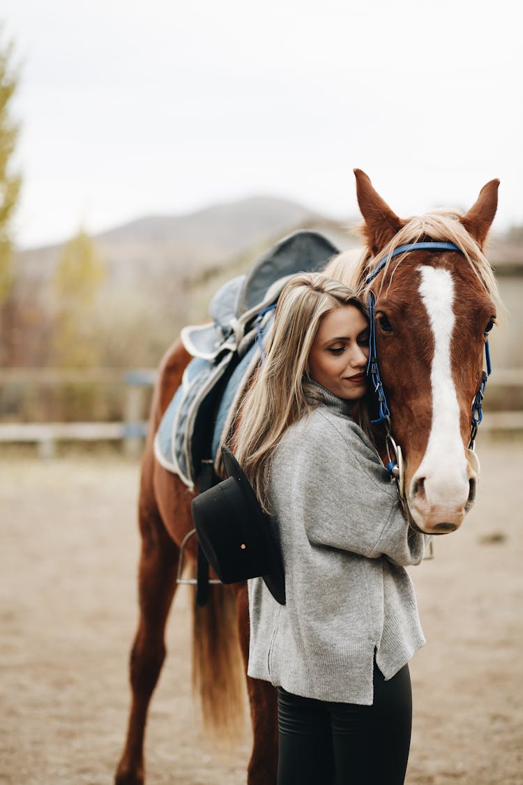 Photo Of A Woman Cuddling A Brown Horse