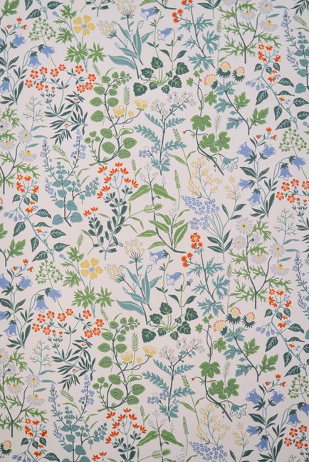 Vibrant floral pattern featuring various plants and flowers, perfect for wallpaper or textiles.