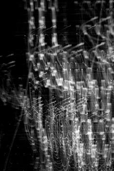 Dynamic abstract light patterns creating a captivating visual in monochrome.