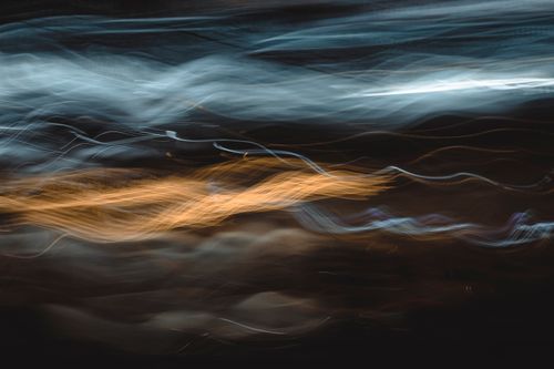 Free Captivating abstract image of colorful light streaks on a dark background, perfect for creative projects. Stock Photo