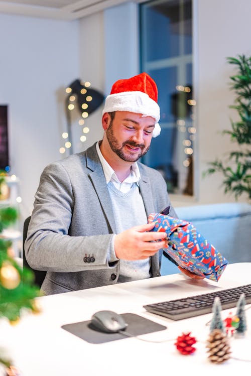 Photograph of a Man Holding a Christmas Present