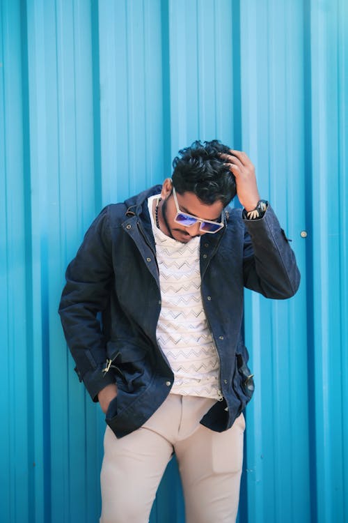 A Guy Posing Near A Steel Wall