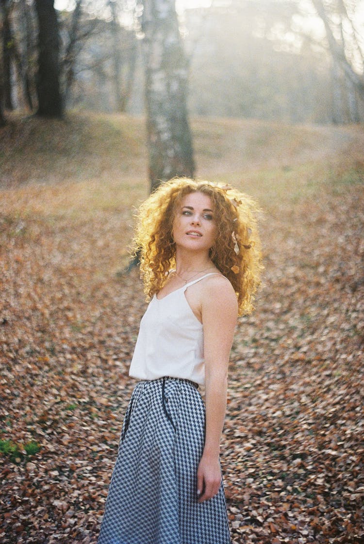 Woman In Blouse And Skirt In Autumn Park