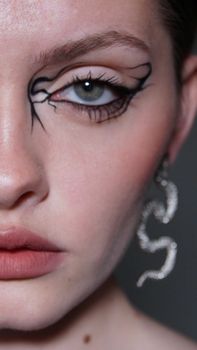 Close-up of a woman's eye with intricate artistic makeup design in Ukrainka, Ukraine.