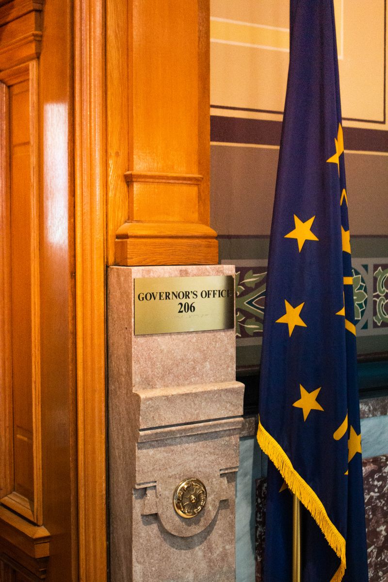 Interior view of Indiana Statehouse featuring Governor's Office sign and state flag.
