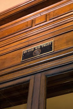 Elegant wooden interior featuring the "In God We Trust" plaque, symbolizing American values.