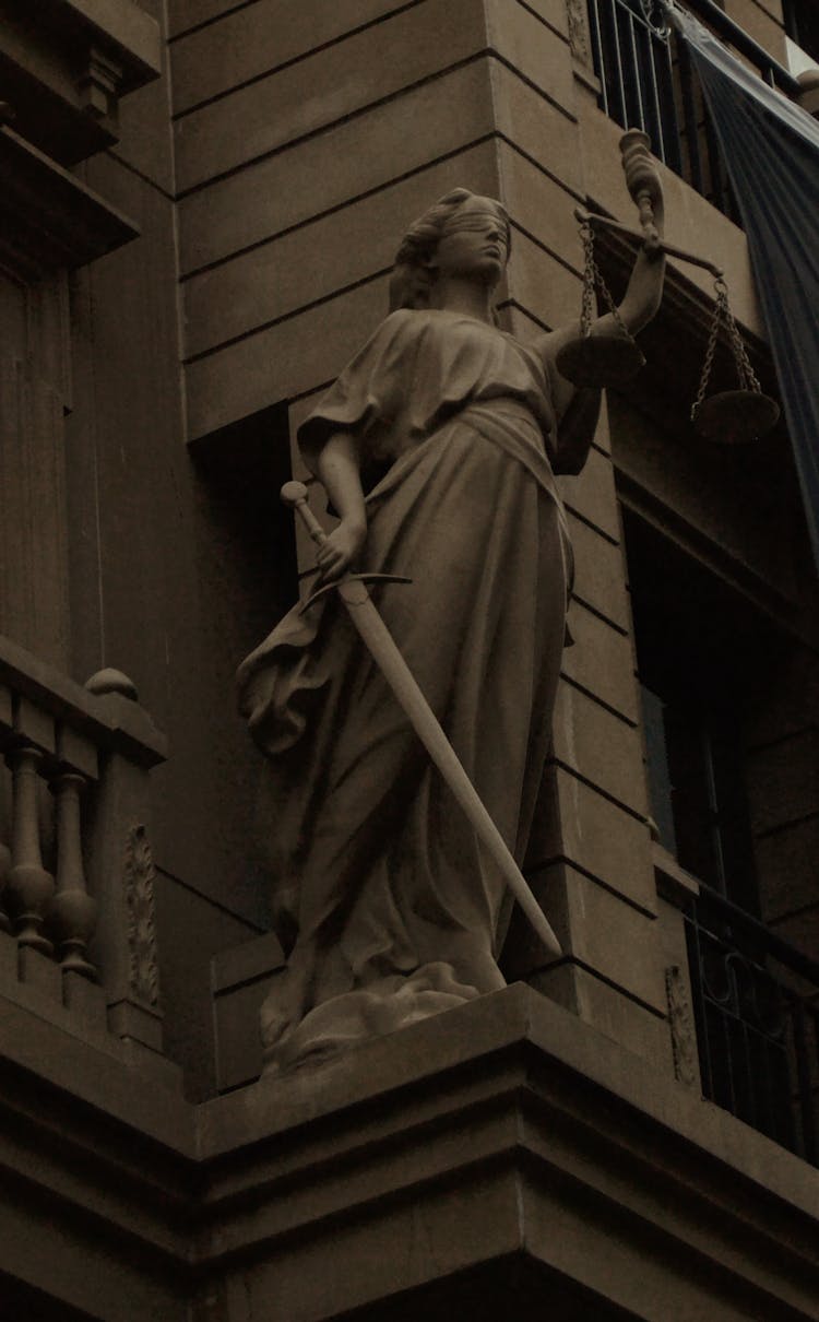 Lady Justice Statue Beside A Building