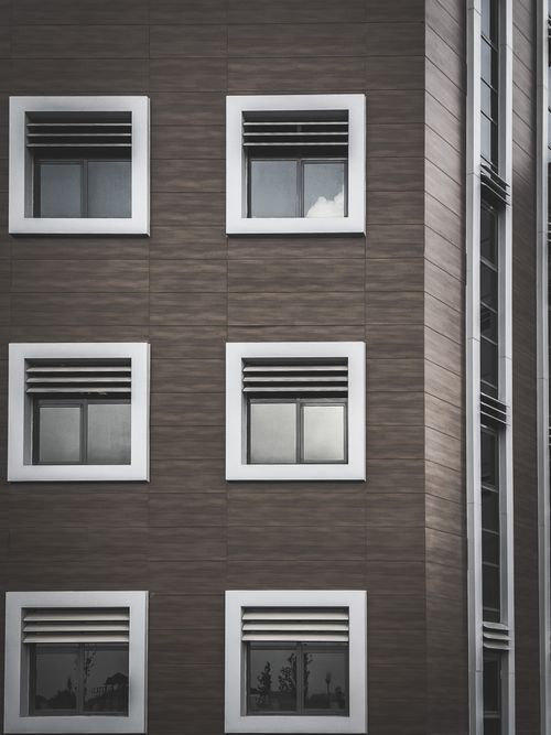 Free Sleek modern facade of a residential building featuring symmetrical windows. Stock Photo